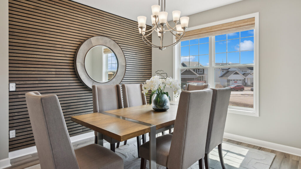 Lennar dining room with fresh flowers and wall acents