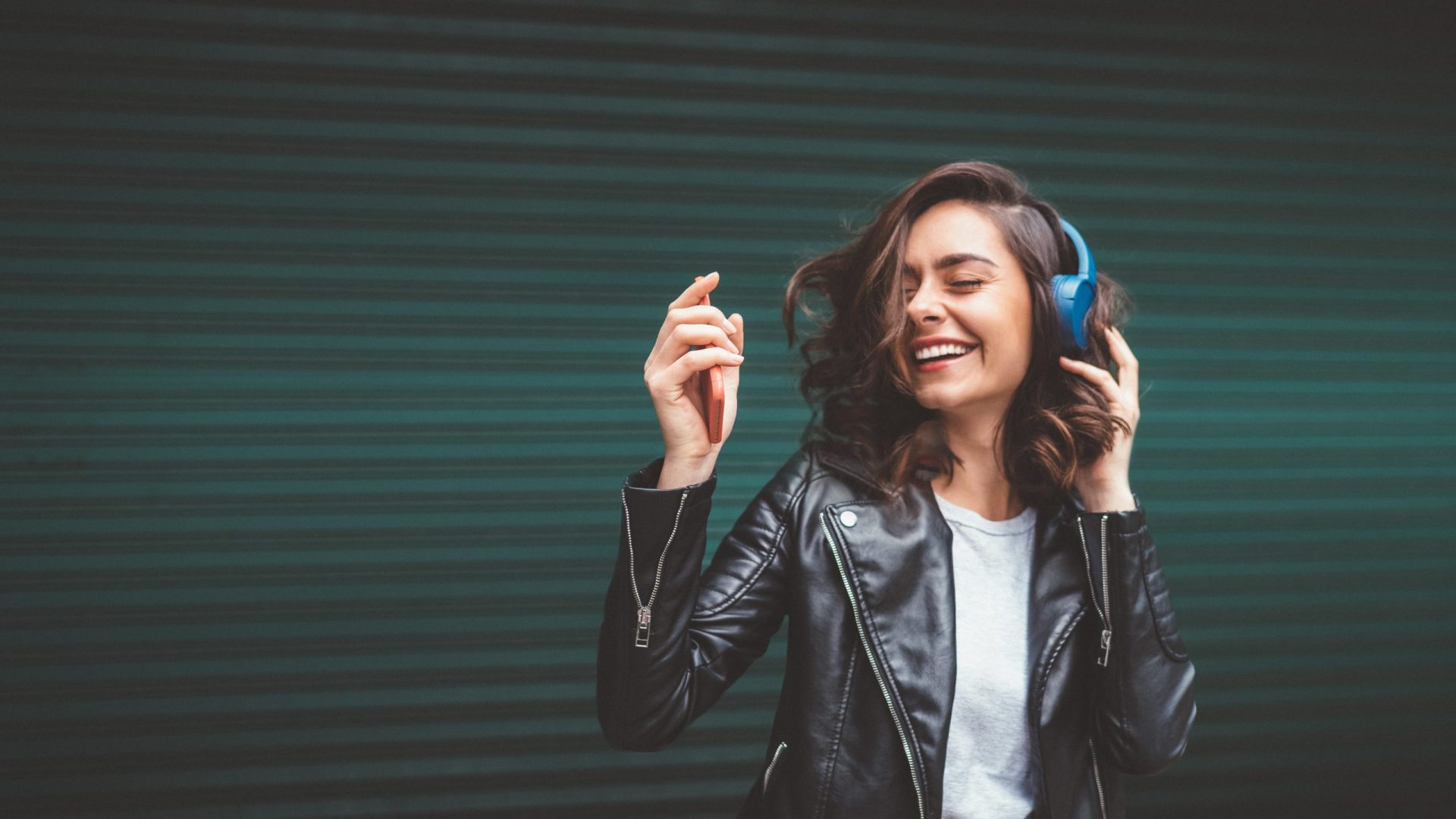 Woman dancing with headphones happy