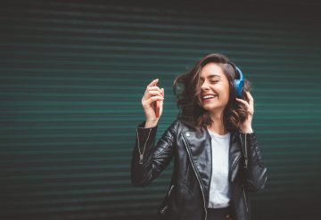 Woman dancing with headphones happy