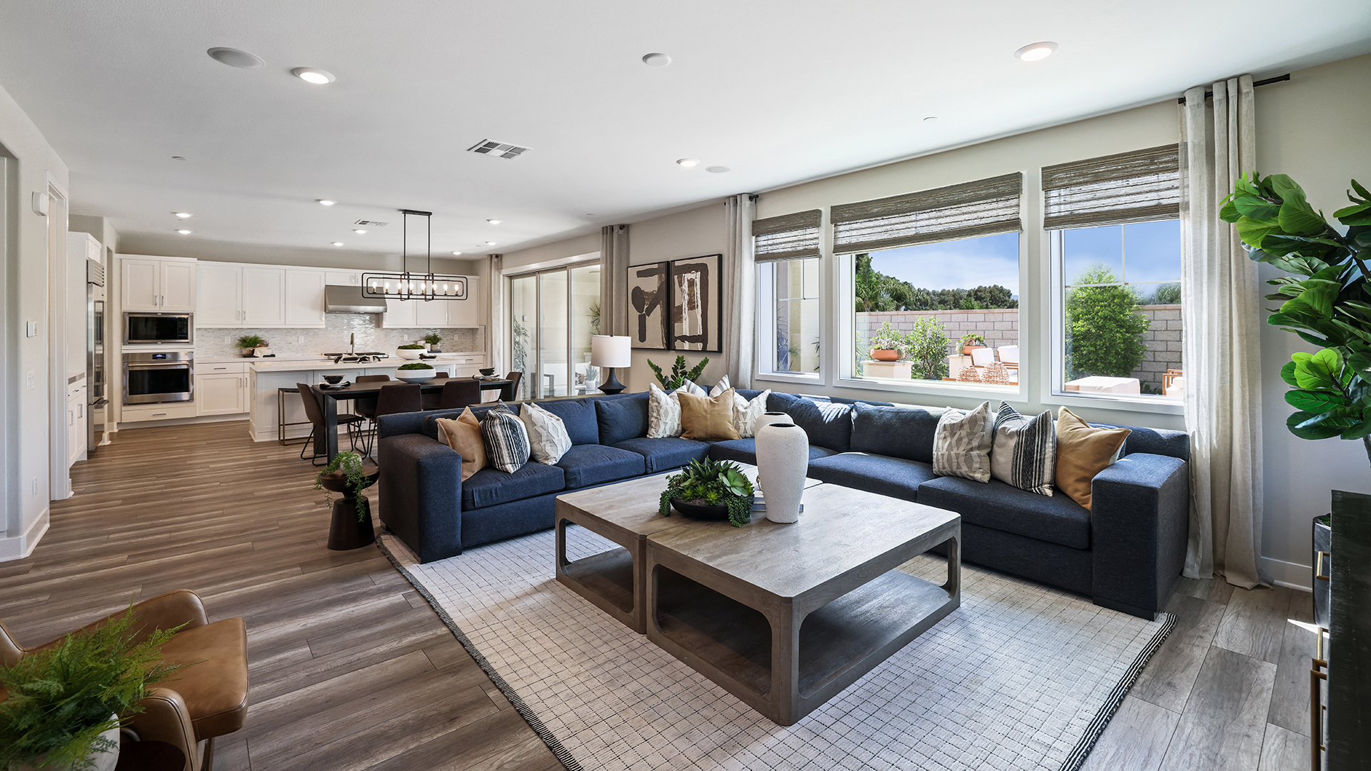 Lennar open concept living room with blue sectional sofa