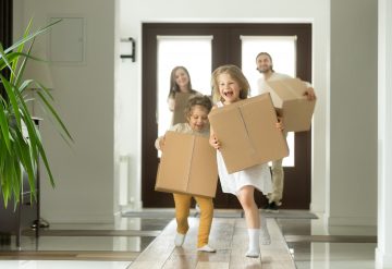 kids running while moving boxes