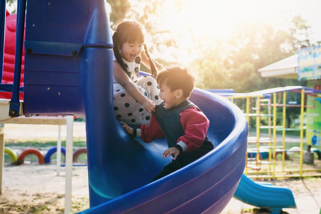 Playground with two kids on slide