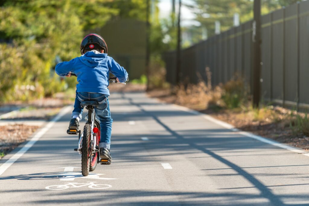 child outside riding a bike on the trail