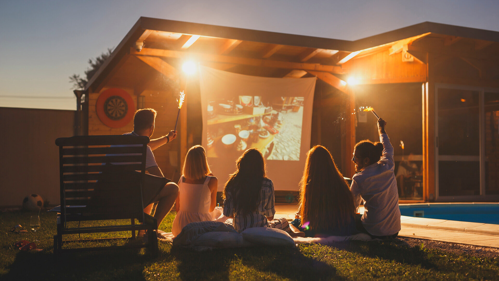 family outside in the backyard summer movie night