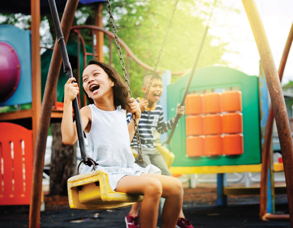 Kids on the Playground Girl Swinging