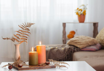 Stock photo of a living area with a coffee table with candles and cozy blankets