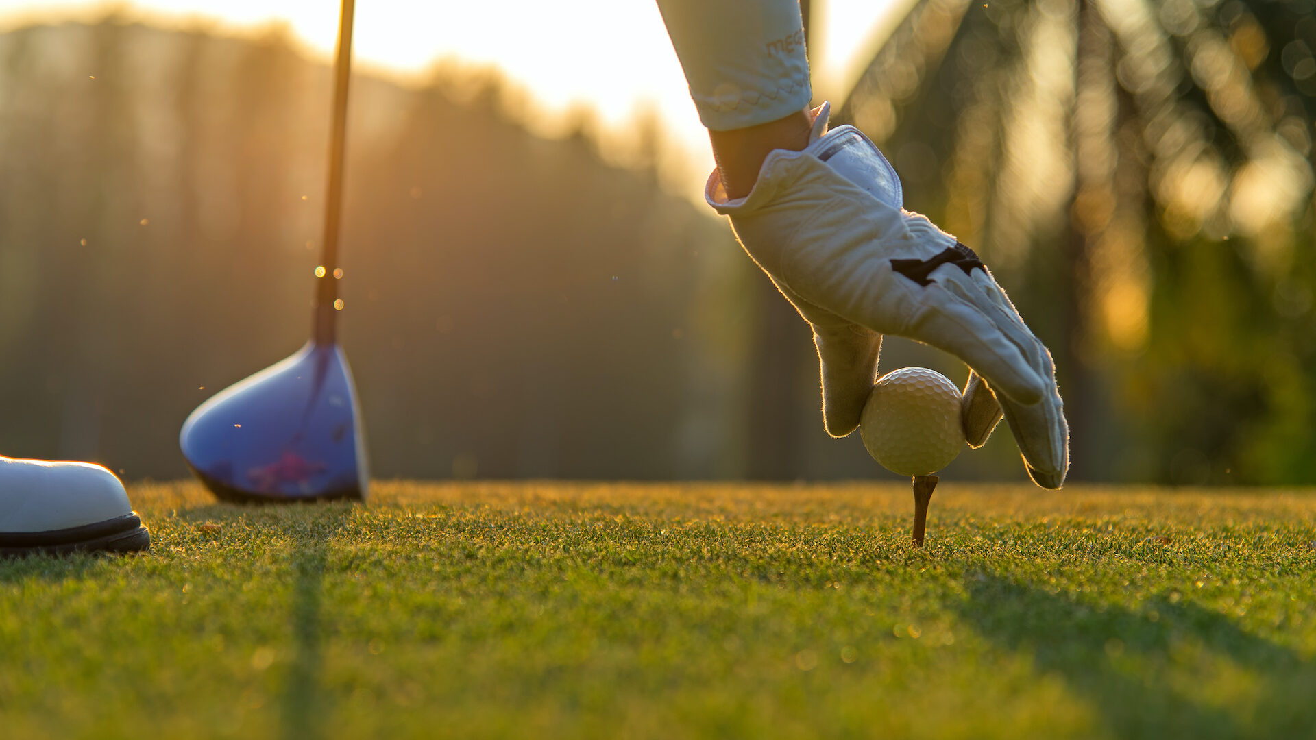 Stock photo of a golfer holding a ball with their hand