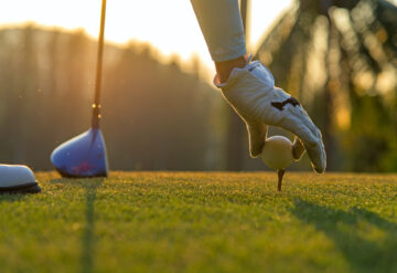 Stock photo of a golfer holding a ball with their hand
