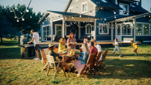 Stock photo of a family enjoying a BBQ outdoors in their backyard