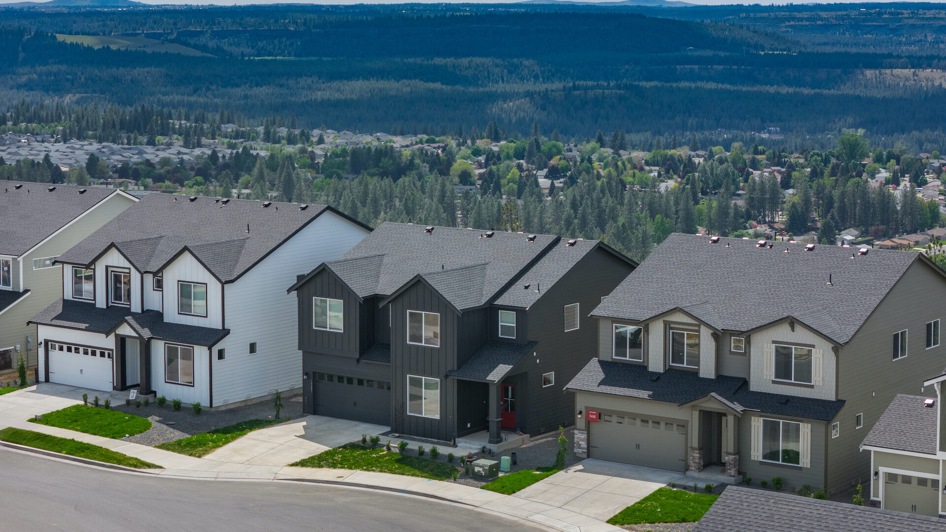 Aerial shot of three homes at the Woodridge community in Spokane