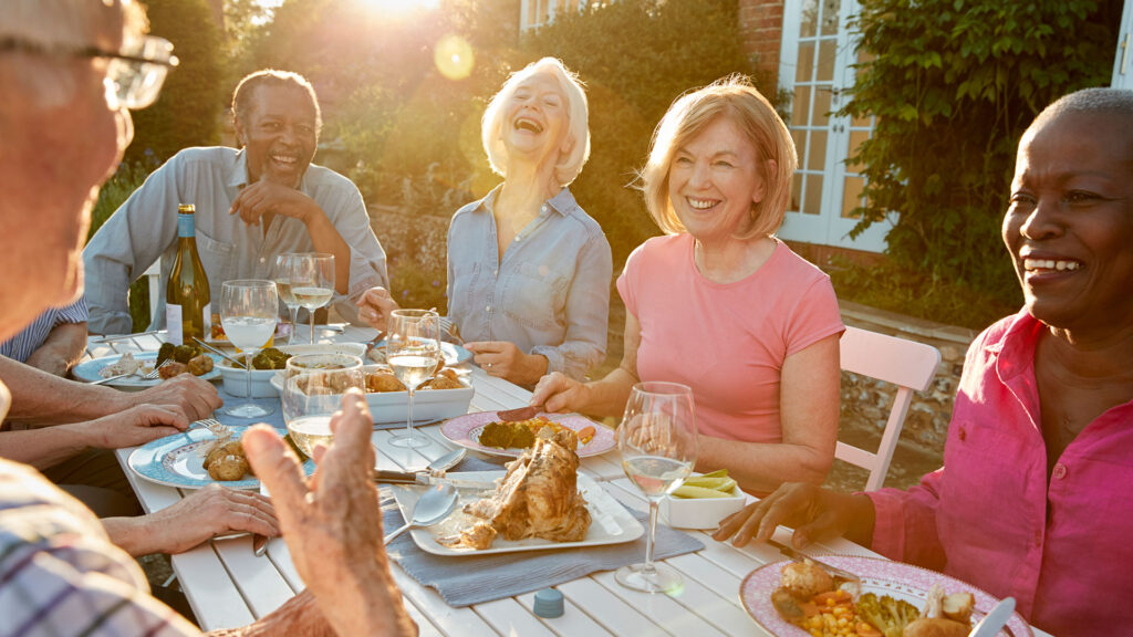 Active adults eating dinner outside