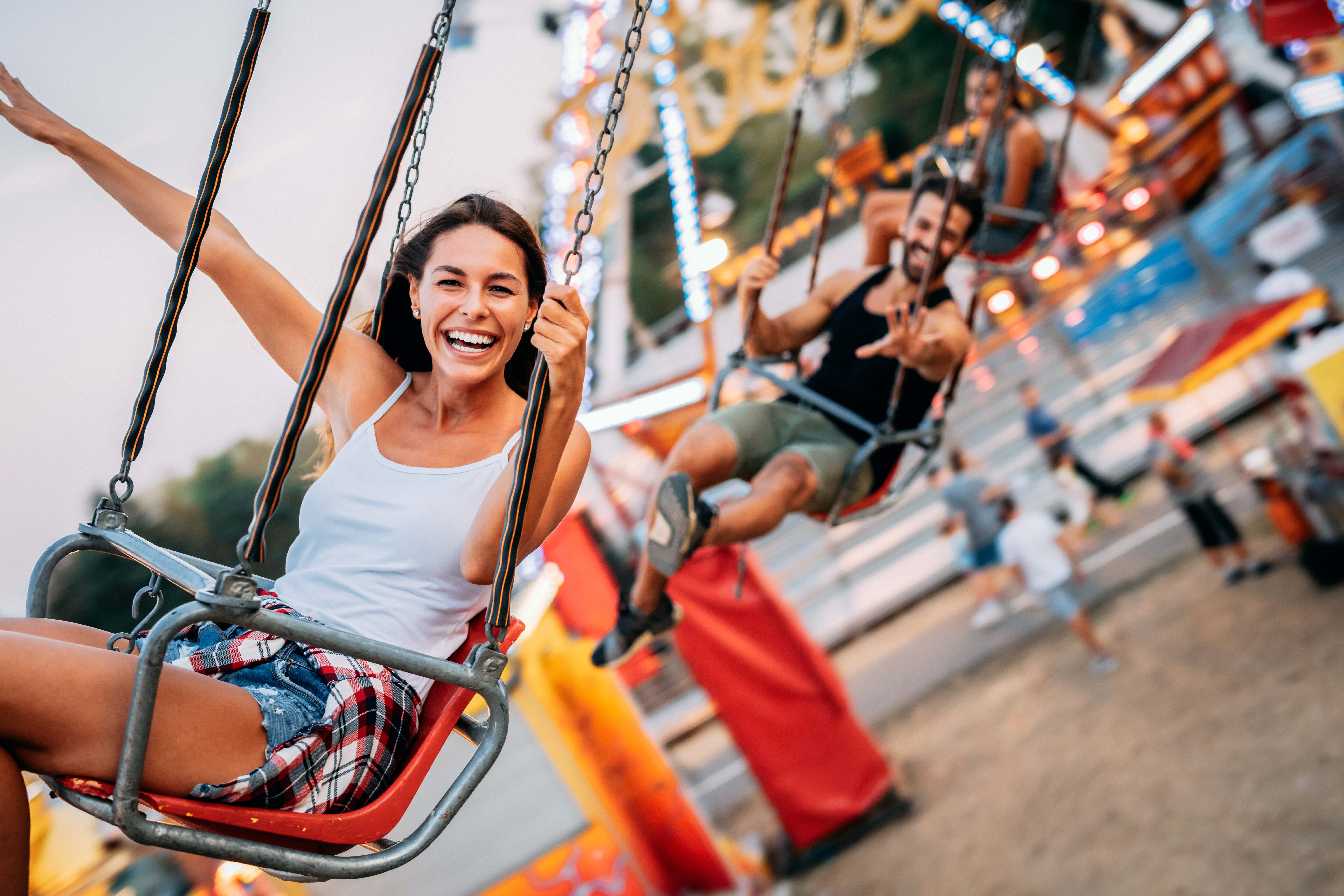 people riding the outdoor swings ride
