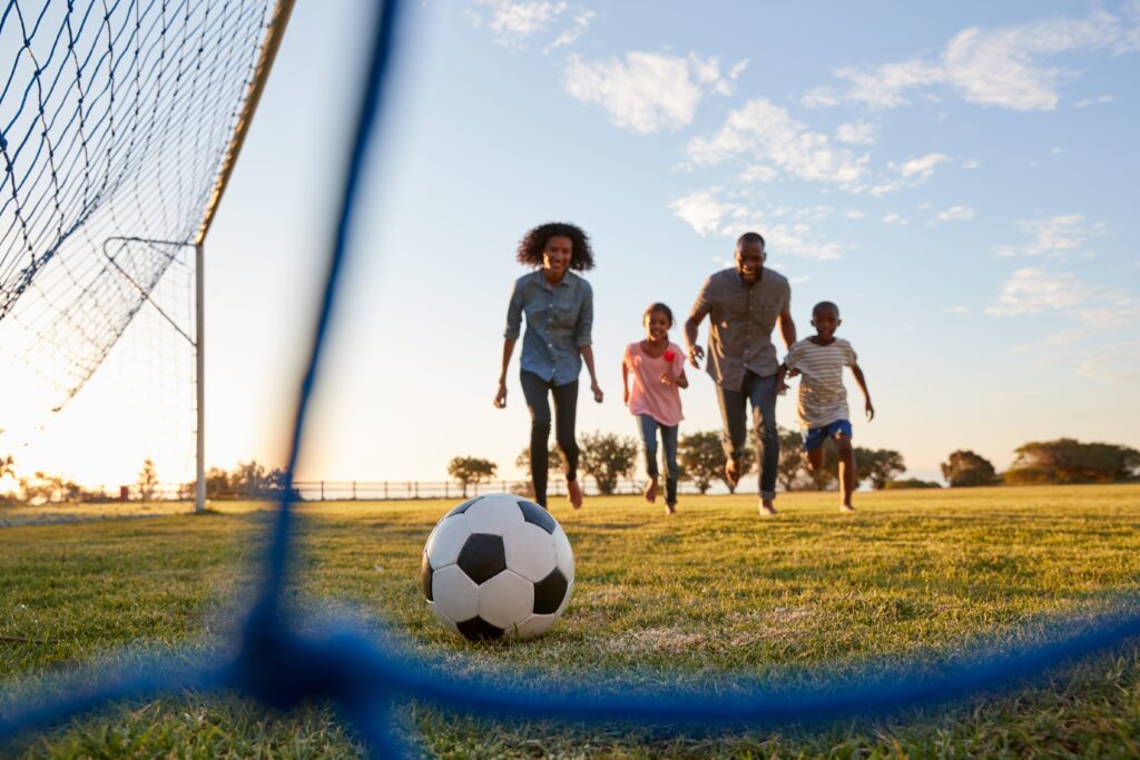 Family Outdoors playing soccer