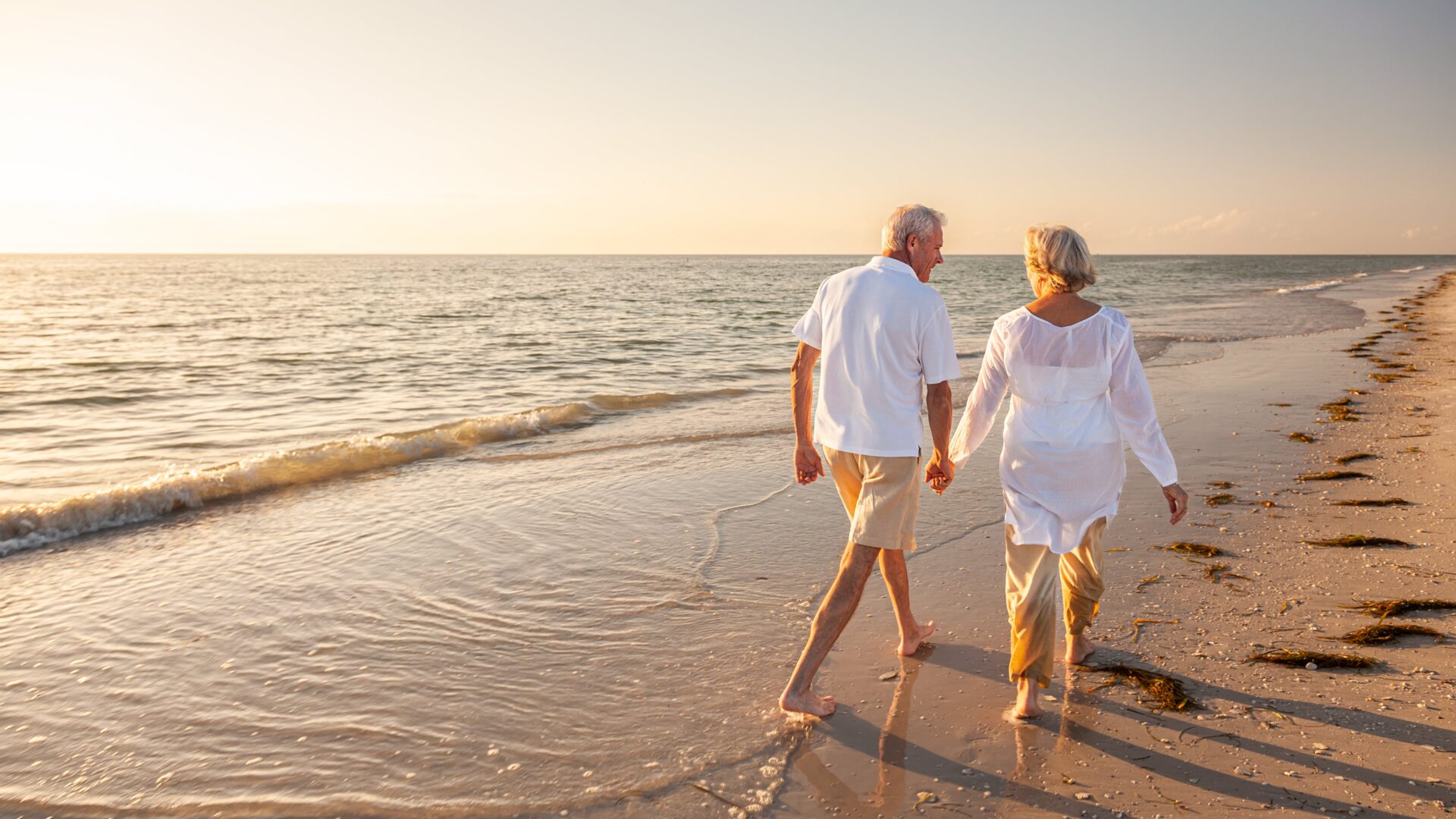 Active adults walking on the beach