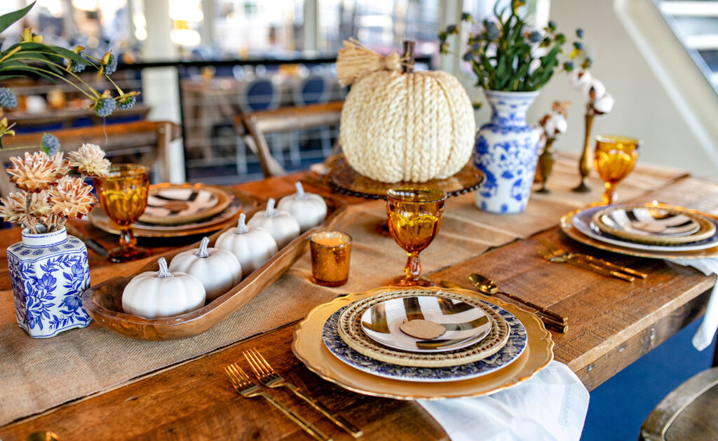 dinner table place setting with a pumpkins