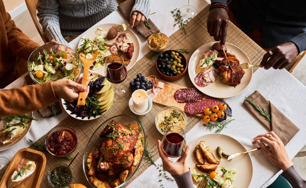 Thanksgiving menu all around the table sharing food