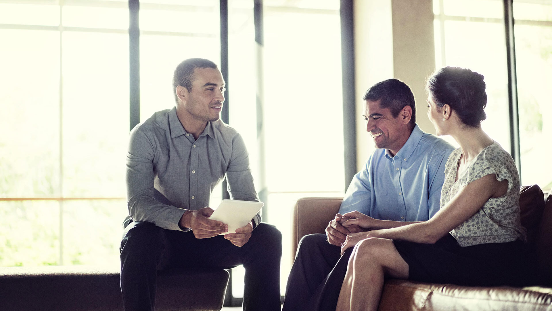 Broker Realtor with Couple Sitting