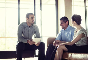 Broker Realtor with Couple Sitting